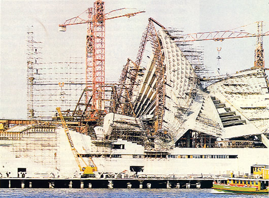 The Sydney Opera House during construction, featuring Cyclone scaffolding.