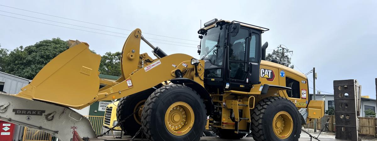CAT excavator 938 on a truck being delivered to the Noosa plant