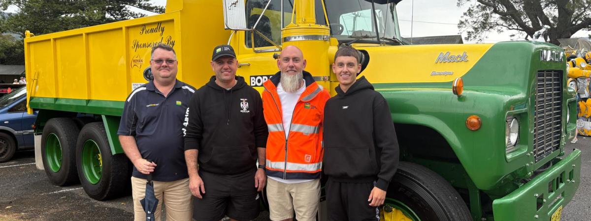 family standing in front of vintage Boral truck at Jamberoo Car Show 2025