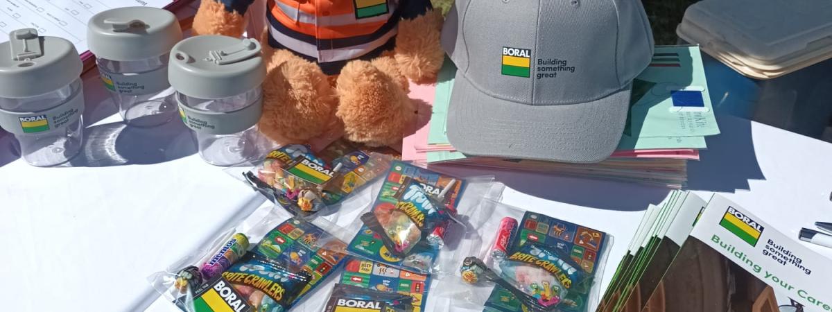 Boral merchandise on a table with a teddy bear in PPE