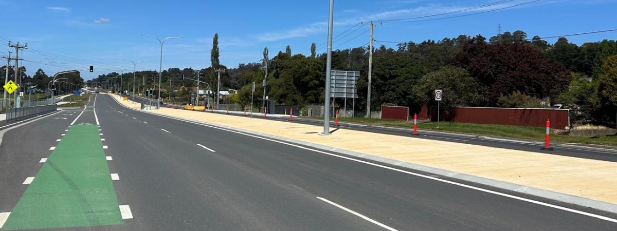 close up of highway with yellow coloured concrete island in centre
