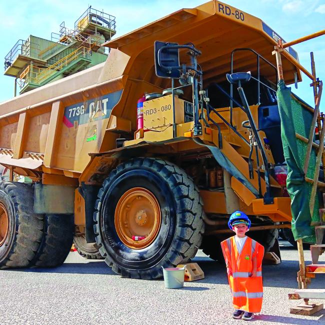 Reggie in PPE in front of Heavy Vehicle