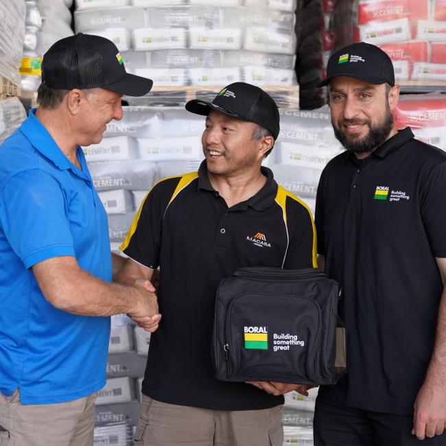 Winner F.L. Jia accepting a TEMPEST Spa prize from Boral Account Manager Ersin Teke and Seymours Building Supplies owner Justin Bucciarelli.