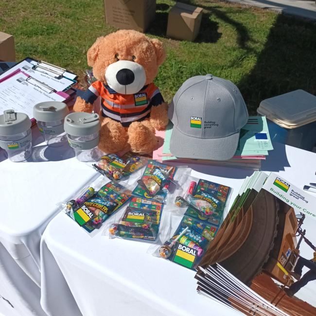 Boral merchandise on a table with a teddy bear in PPE