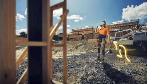 Man carrying bag of Boral packaged cement