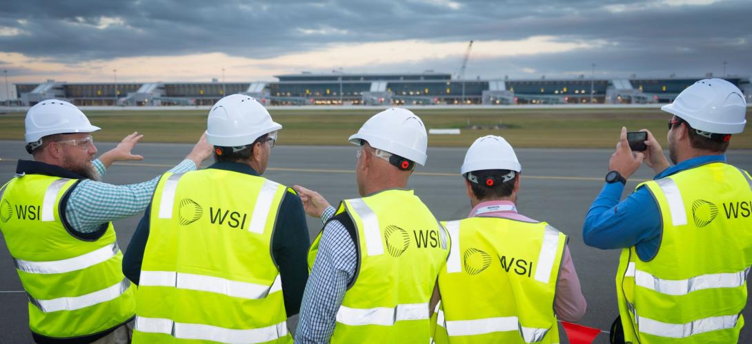 People in high vis vests and ahrd hats at Western Sydney Airport