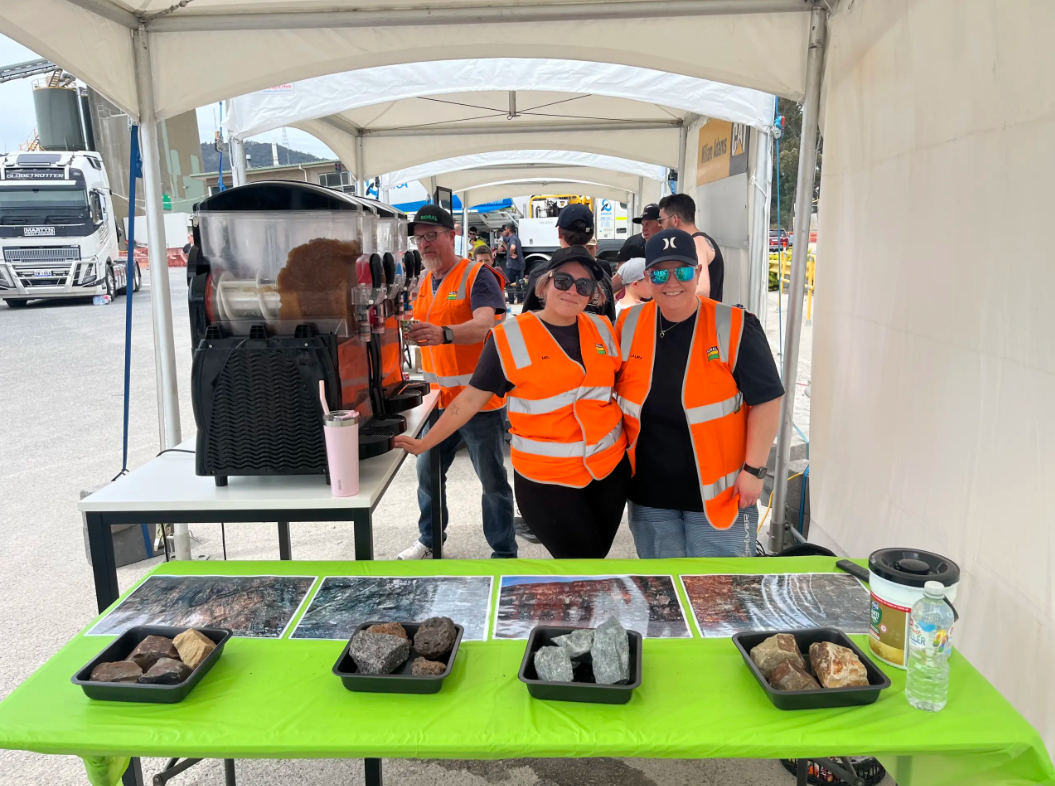 Employees in PPE serving a barbeque