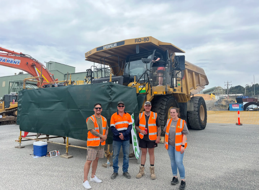 Group in PPE with Heavy Vehicle