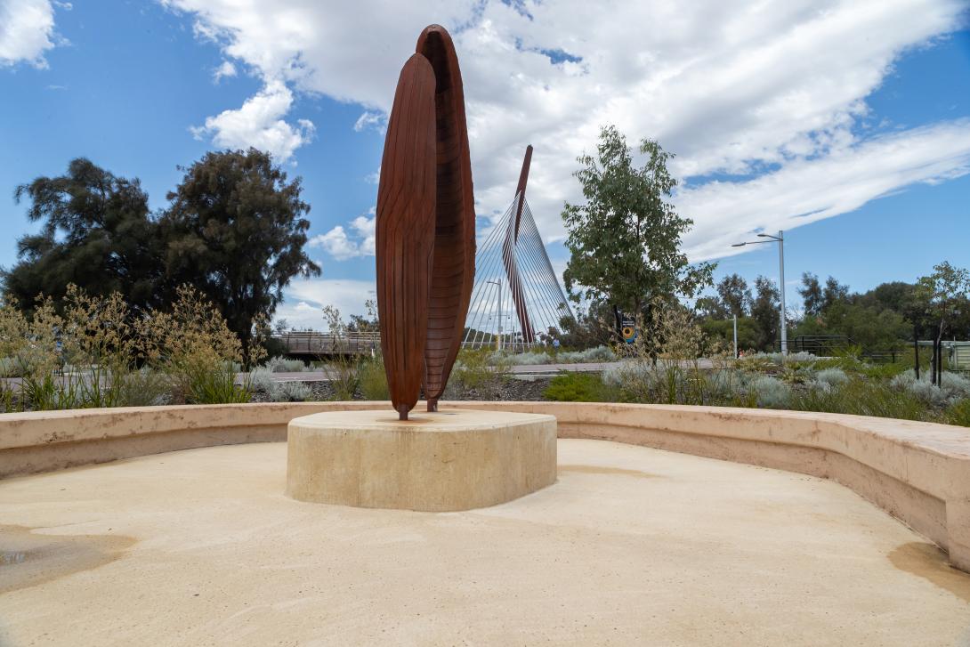 Coloured concrete pathway on Heirisson Island featuring Colori® Turmeric finish, connecting landscaped public spaces near Boorloo Bridge in Perth