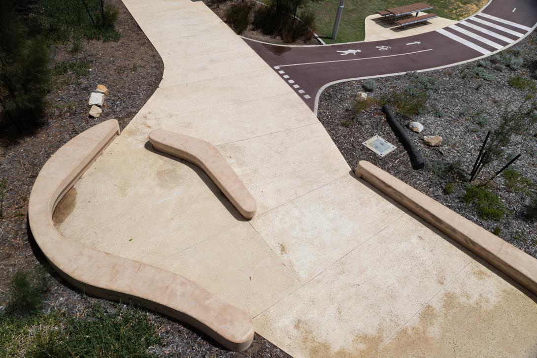 Coloured concrete pathway on Heirisson Island featuring Colori® Turmeric finish, connecting landscaped public spaces near Boorloo Bridge in Perth