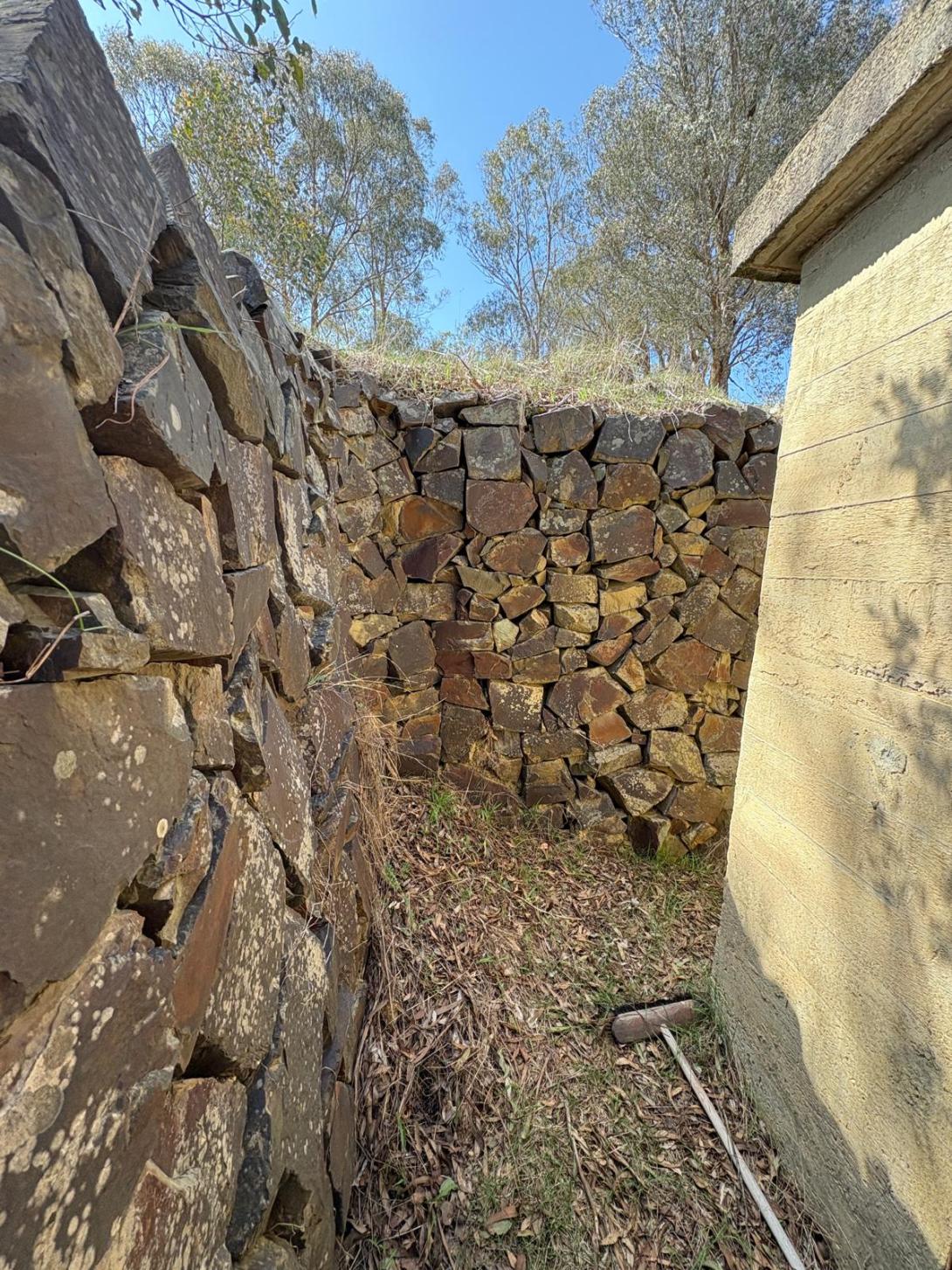 Detail of dry-stone wall constructed without mortar around the Coldstream Quarry explosives magazine