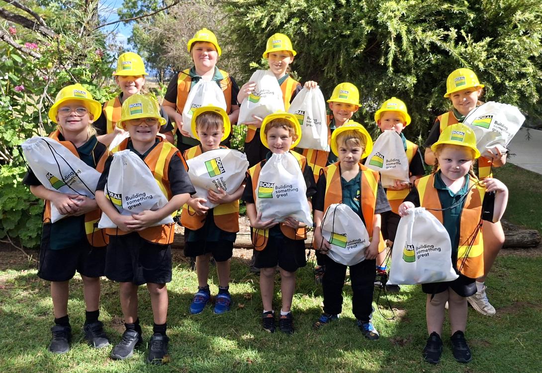 Students at Booyal Central State School wearing Boral hard hats and hi-vis vests with their showbags
