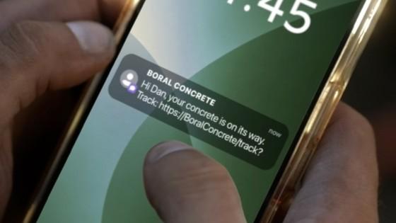 Close up of mobile phone showing notification that concrete delivery is on the way